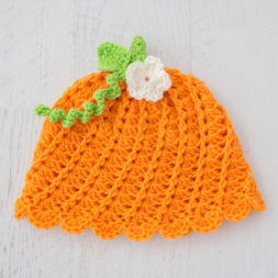 free crochet pattern & tutorial, crochet pumpkin beanie, how to crochet a pumpkin beanie hat, crochet halloween hat, crochet thanksgiving hat, crochet autumn hat, crochet pumpkin beanie and flower, free crochet pattern, pumpkin beanie tutorial, orange, green, and white beanie